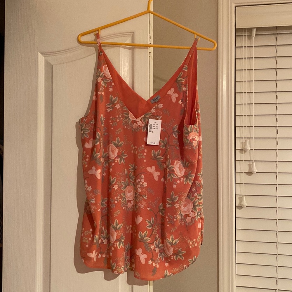 Kismet L spaghetti strap tank. Rounded slit bottom on sides. 100%polyester.